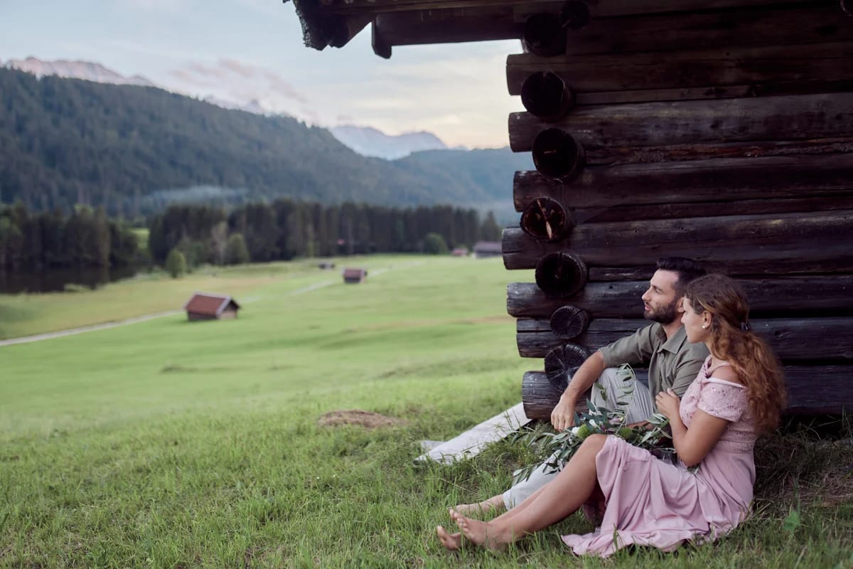 Couple in a tender embrace on an alpine meadow during a couple photoshoot at Lake Geroldsee