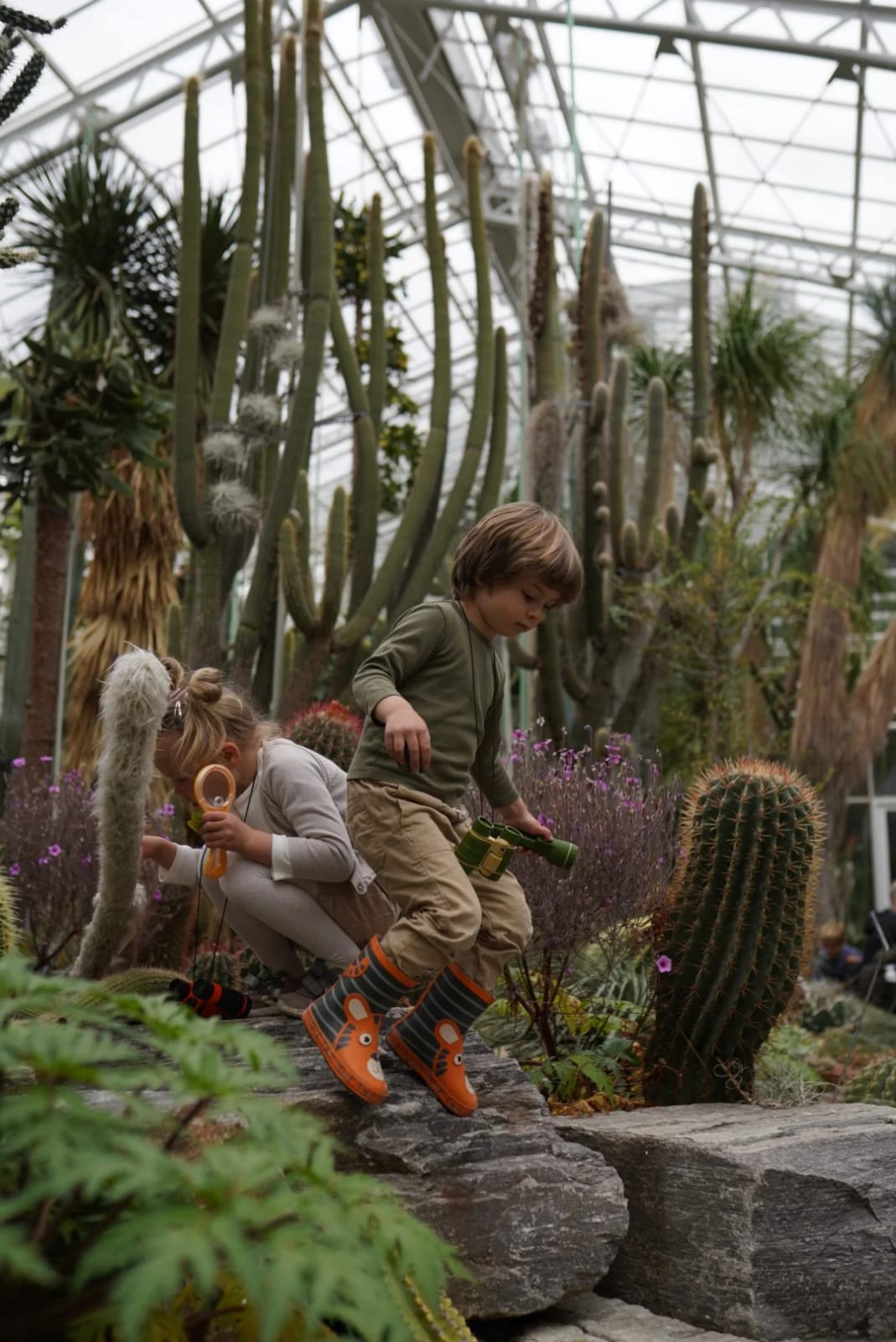 Child in awe among exotic plants during a themed kids shoot in Munich