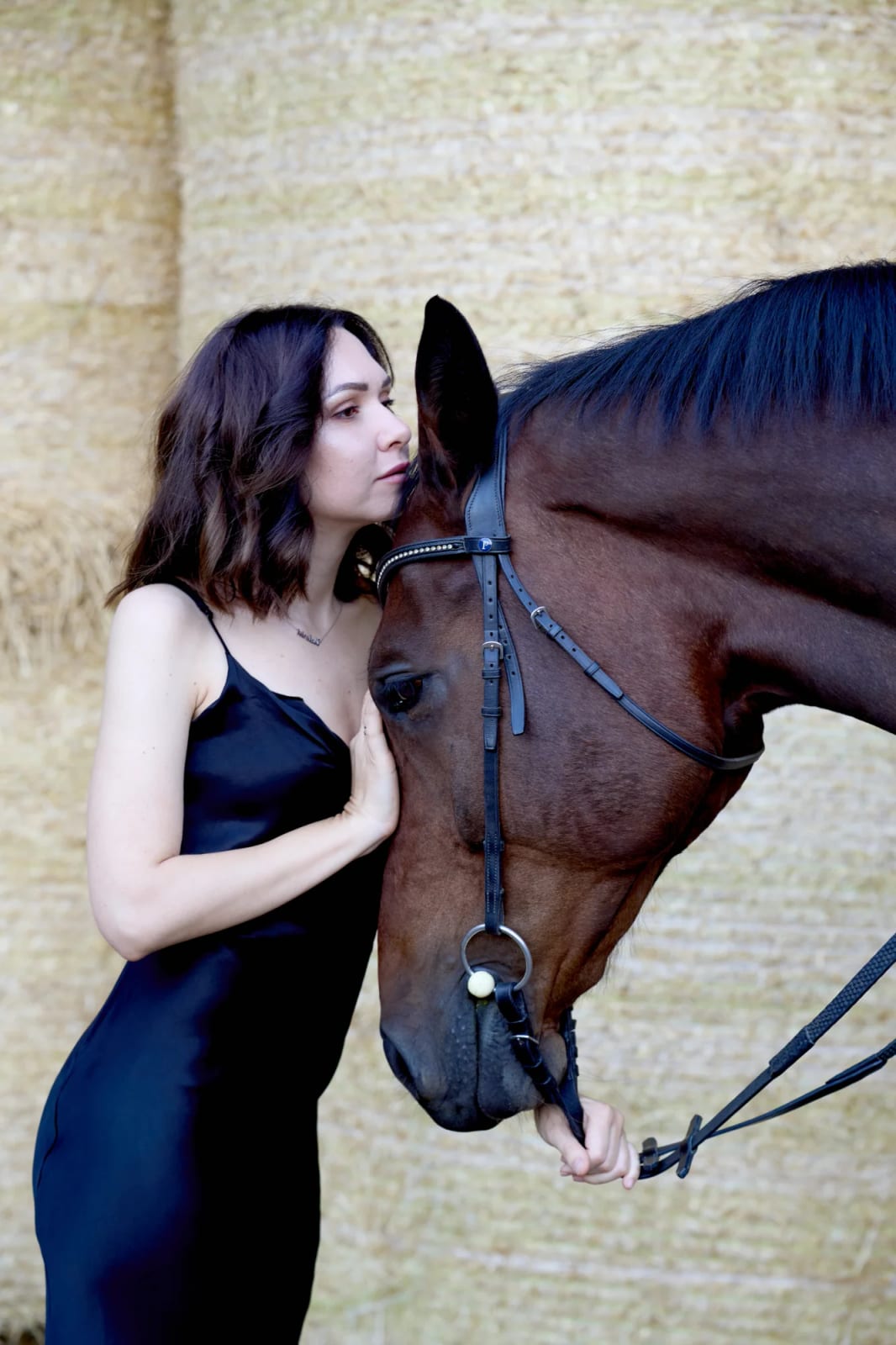 Rider resting her forehead against her horse's head – a tender moment during a horse photoshoot